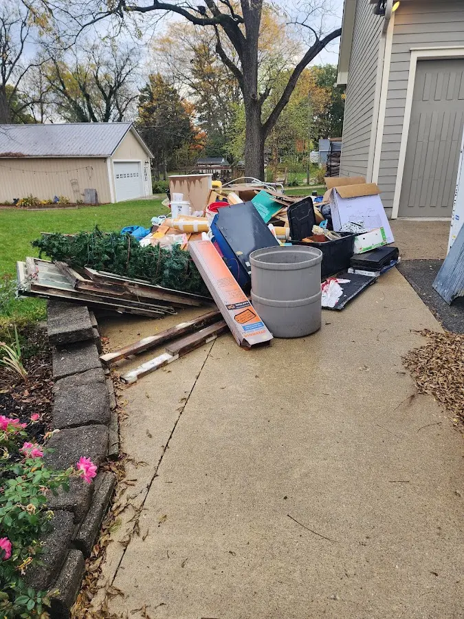 Dumpster being loaded with debris for Estate Cleanout Dumpster Rental in Nottawa